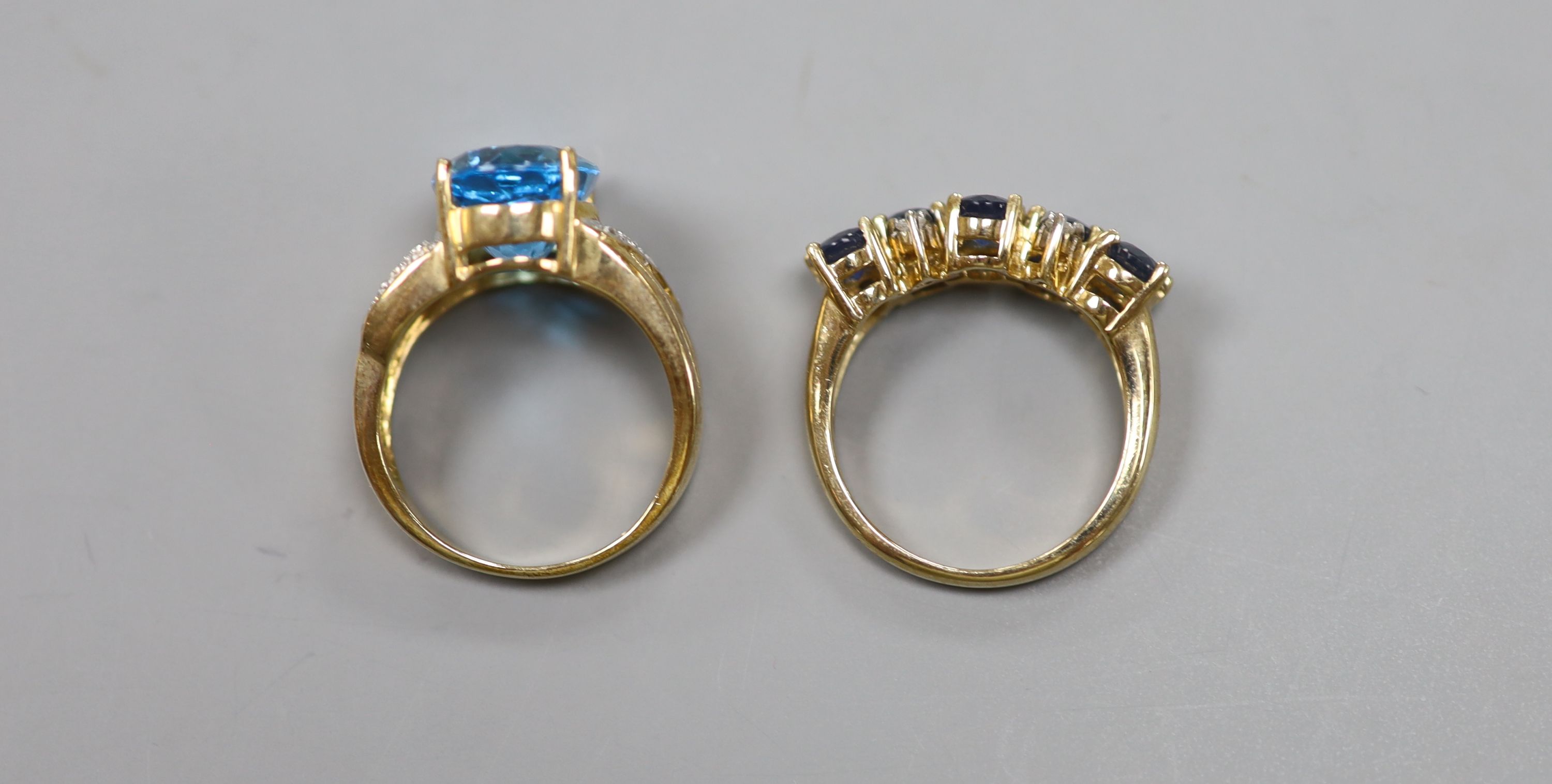 A sapphire and diamond double line ring, 9ct gold shank and another 9ct gold ring set blue and white topaz